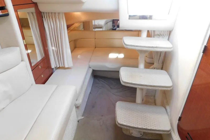 Slide: The Image of Interior of 2001 Sea Ray 300 Sundancer yacht with white seating and steps. - 42
