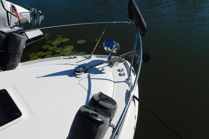 Slide: The Image of Bow of 2001 Sea Ray 300 Sundancer with anchor and railing on calm water. - 6
