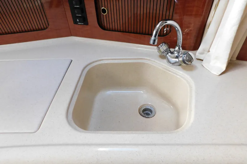 Slide: The Image of Kitchen sink and faucet on a 2001 Sea Ray 300 Sundancer boat. - 50