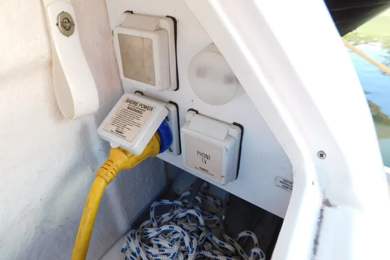 Slide: The Image of Electrical connections on a 2001 Sea Ray 300 Sundancer boat with shore power plug. - 13