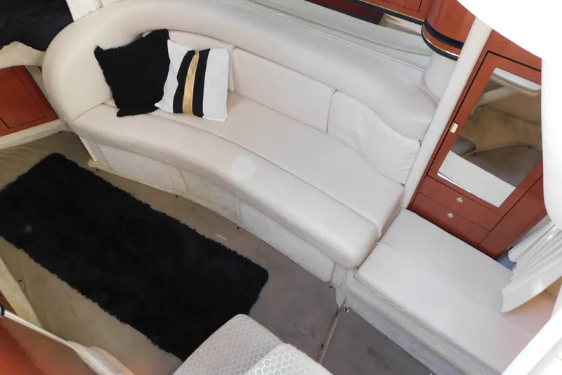 Slide: The Image of Luxurious interior of 2001 Sea Ray 300 Sundancer with white seating and decorative pillows. - 39