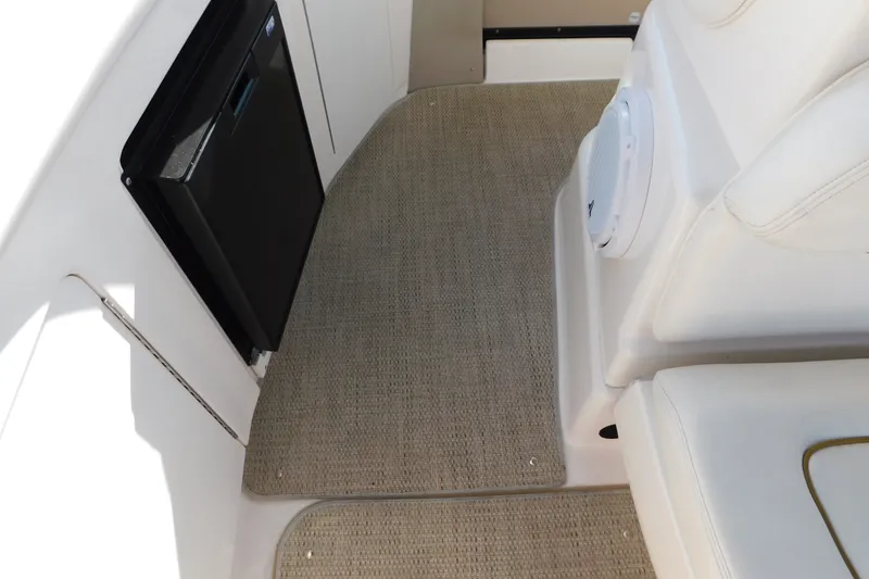 Slide: The Image of Interior view of a 2001 Sea Ray 300 Sundancer boat with seating and carpeted flooring. - 79