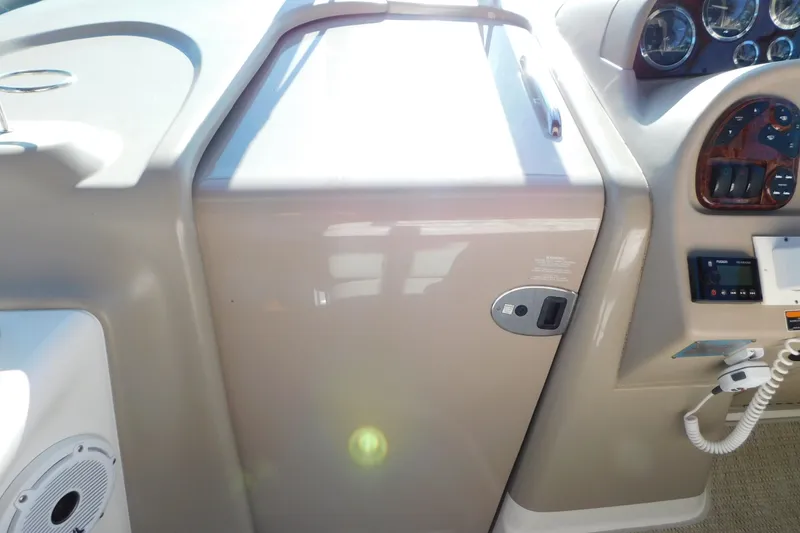 Slide: The Image of 2001 Sea Ray 300 Sundancer helm with control panel and speaker. - 34