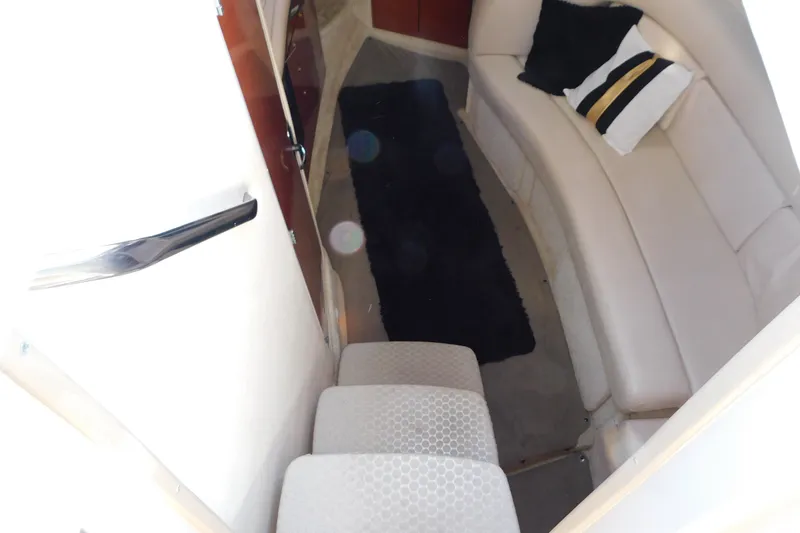 Slide: The Image of Interior of 2001 Sea Ray 300 Sundancer with beige seating and black rug. - 38