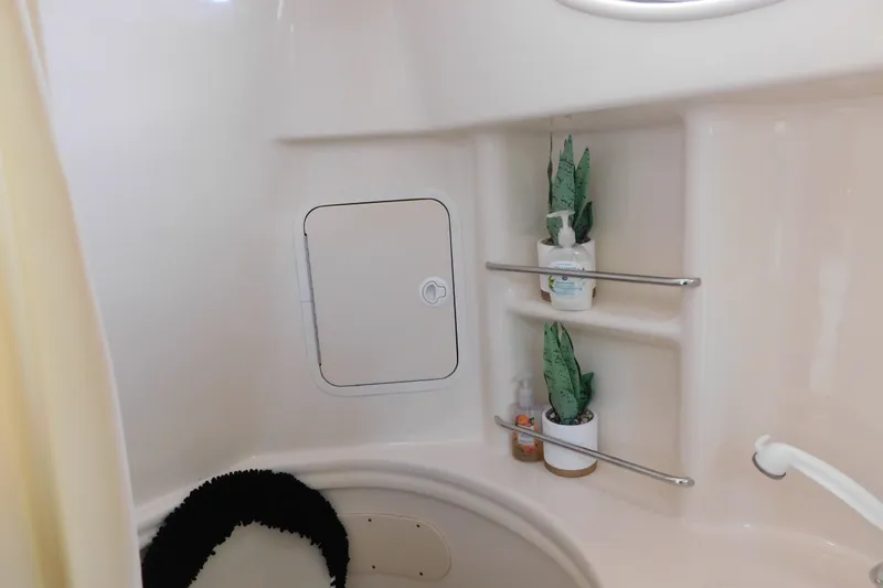Slide: The Image of Bathroom interior of 2001 Sea Ray 300 Sundancer with shelves and plants. - 62