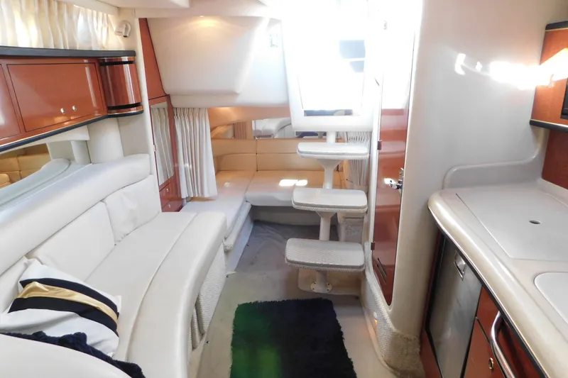Slide: The Image of Interior of 2001 Sea Ray 300 Sundancer yacht with elegant seating and compact kitchen. - 57