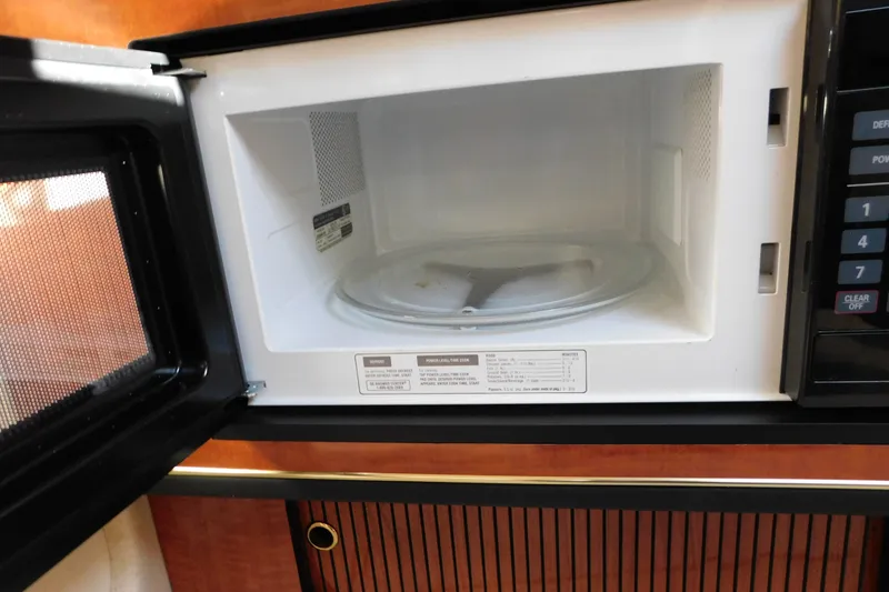 Slide: The Image of Open microwave inside a 2001 Sea Ray 300 Sundancer boat kitchen. - 53
