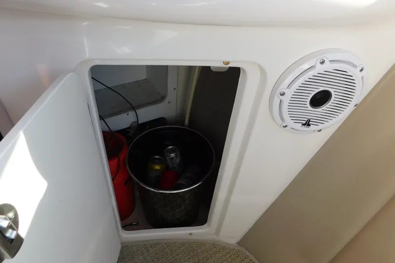 Slide: The Image of Open storage compartment on 2001 Sea Ray 300 Sundancer boat with speaker and drinks. - 24