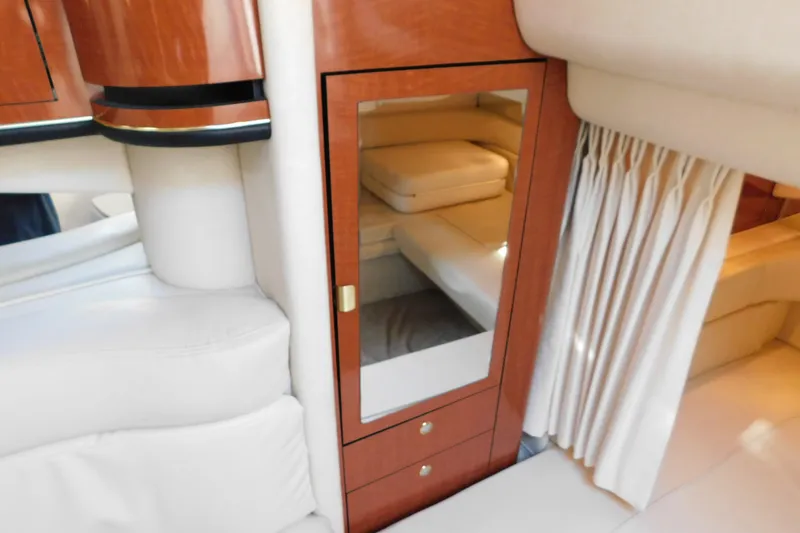 Slide: The Image of Interior of 2001 Sea Ray 300 Sundancer with wood cabinetry and mirrored door. - 43