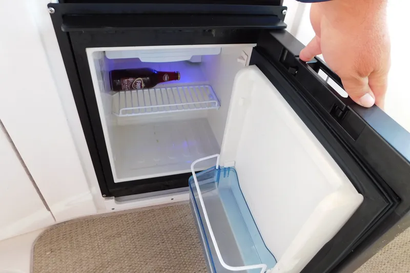 Slide: The Image of Mini fridge on 2001 Sea Ray 300 Sundancer boat with a bottle inside. - 22