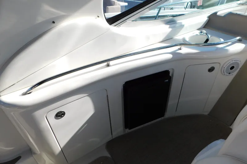 Slide: The Image of Interior view of a 2001 Sea Ray 300 Sundancer boat, featuring sleek cabinetry and a compact design. - 19