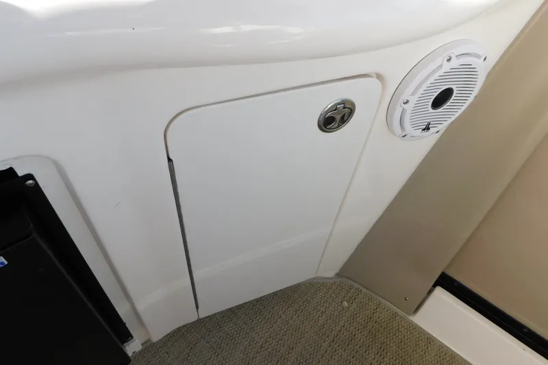 Slide: The Image of Interior detail of a 2001 Sea Ray 300 Sundancer boat, featuring a speaker and storage compartment. - 23