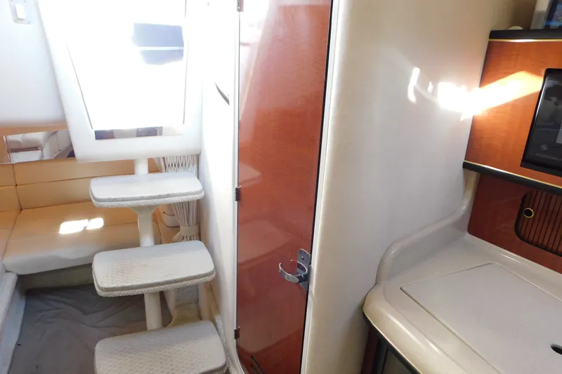 Slide: The Image of Interior of 2001 Sea Ray 300 Sundancer with steps, seating, and cabinetry. - 58