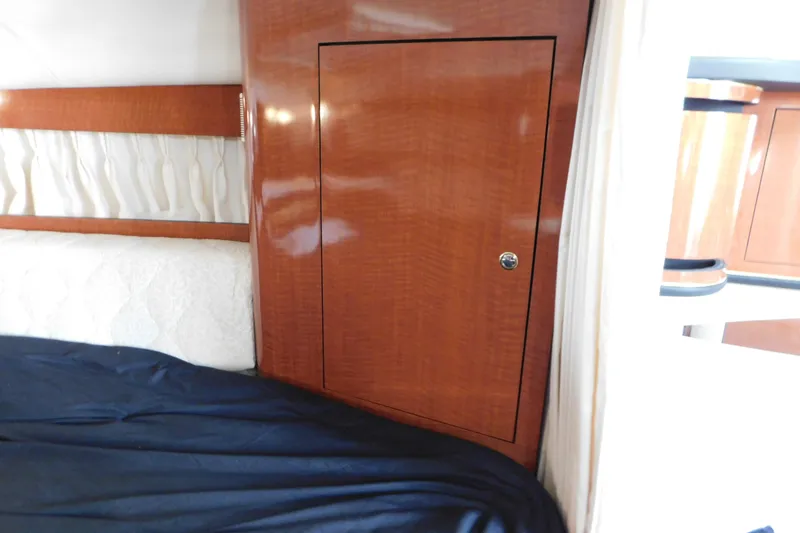 Slide: The Image of Interior cabin of 2001 Sea Ray 300 Sundancer with wood paneling and bedding. - 47