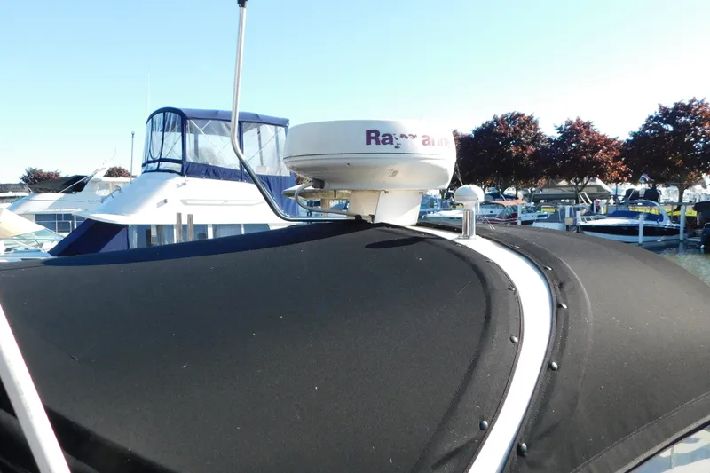 Slide: The Image of 2001 Sea Ray 300 Sundancer with radar, docked at marina under clear sky. - 4