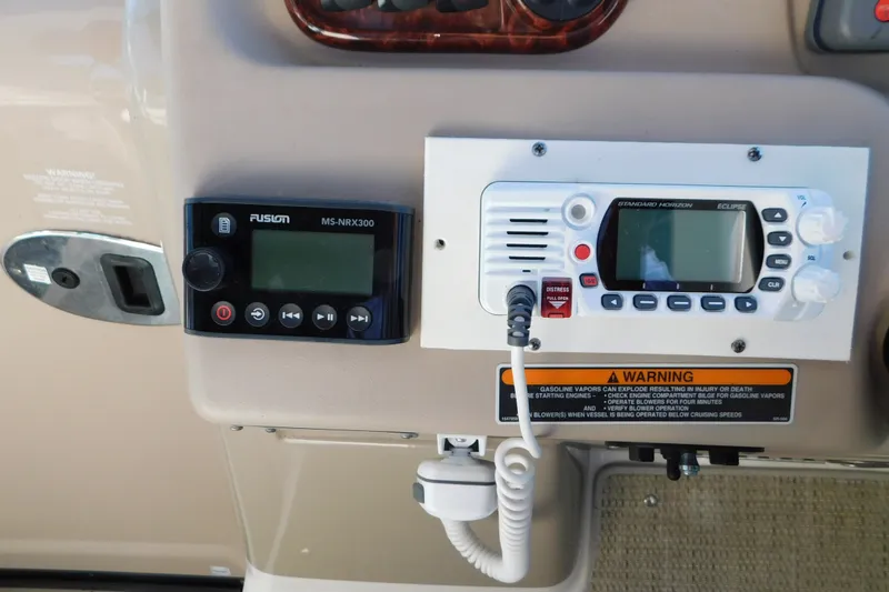 Slide: The Image of Control panel of a 2001 Sea Ray 300 Sundancer with radio and warning label. - 30