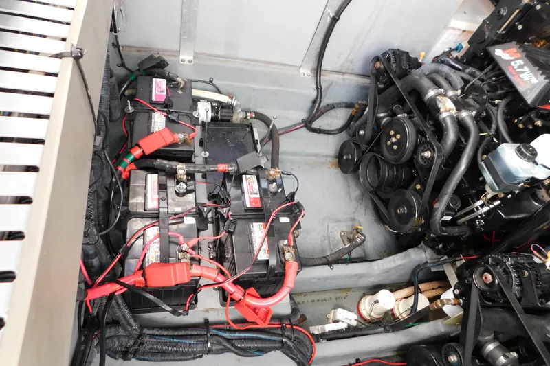 Slide: The Image of Engine compartment of a 2001 Sea Ray 300 Sundancer with batteries and wiring. - 69