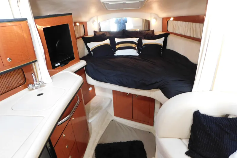 Slide: The Image of Interior of 2001 Sea Ray 300 Sundancer with cozy bed and kitchenette. - 41