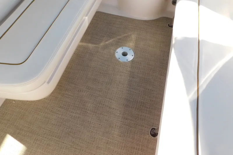 Slide: The Image of 2001 Sea Ray 300 Sundancer boat interior with beige carpet and white seating. - 78