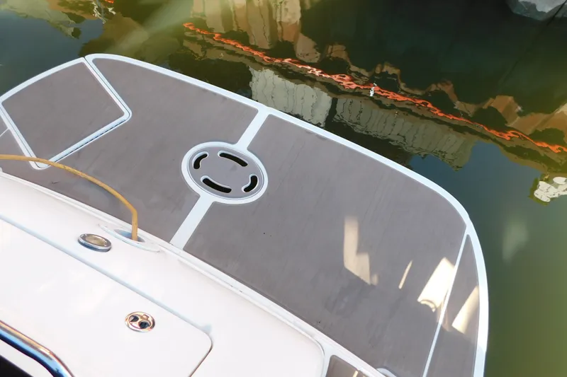 Slide: The Image of Swim platform of a 2001 Sea Ray 300 Sundancer boat docked by the water. - 10