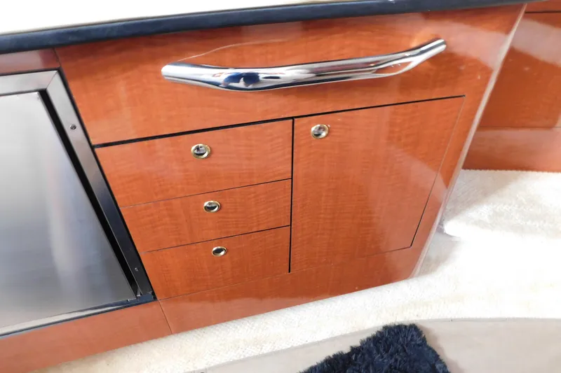 Slide: The Image of Wooden cabinetry with chrome handle in 2001 Sea Ray 300 Sundancer yacht interior. - 56