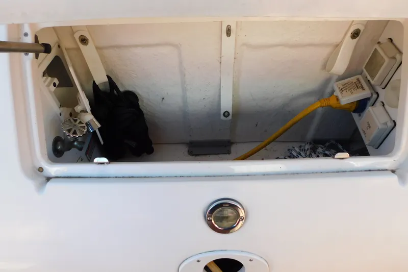 Slide: The Image of Storage compartment of a 2001 Sea Ray 300 Sundancer boat with electrical connections. - 12