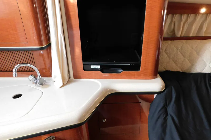 Slide: The Image of Interior of 2001 Sea Ray 300 Sundancer with sink and storage area. - 48