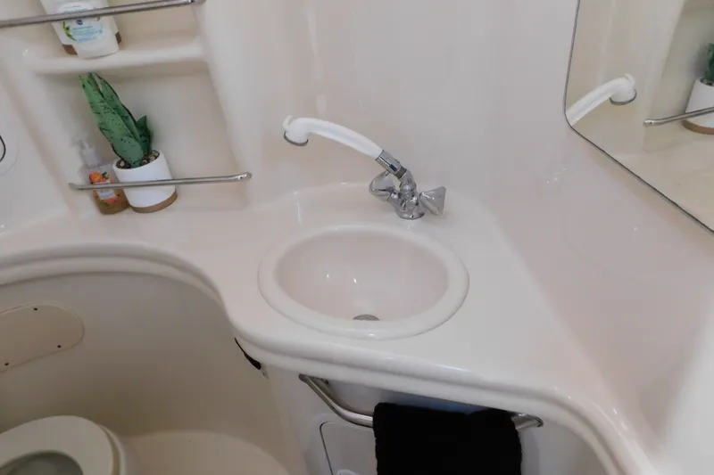 Slide: The Image of Bathroom interior of 2001 Sea Ray 300 Sundancer yacht with sink and toiletries. - 61