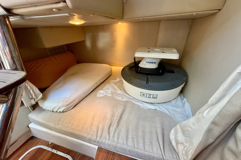 Slide: The Image of 2014 Robalo R305 Walkaround cabin interior with radar equipment on bed. - 27