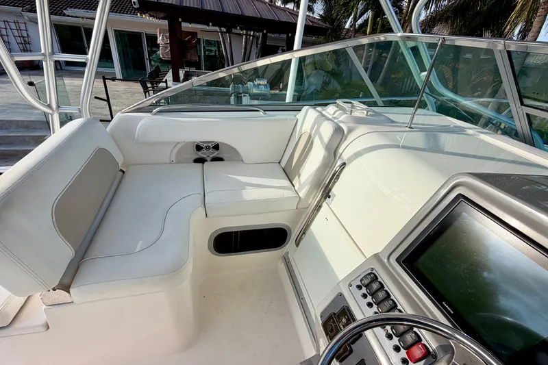 Slide: The Image of 2014 Robalo R305 Walkaround boat interior with seating and control panel. - 13