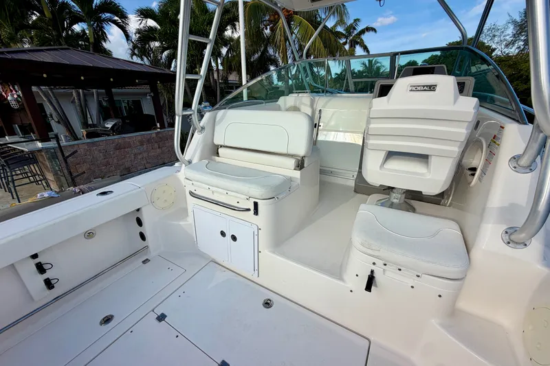 Slide: The Image of 2014 Robalo R305 Walkaround boat interior with white seating and helm station. - 18