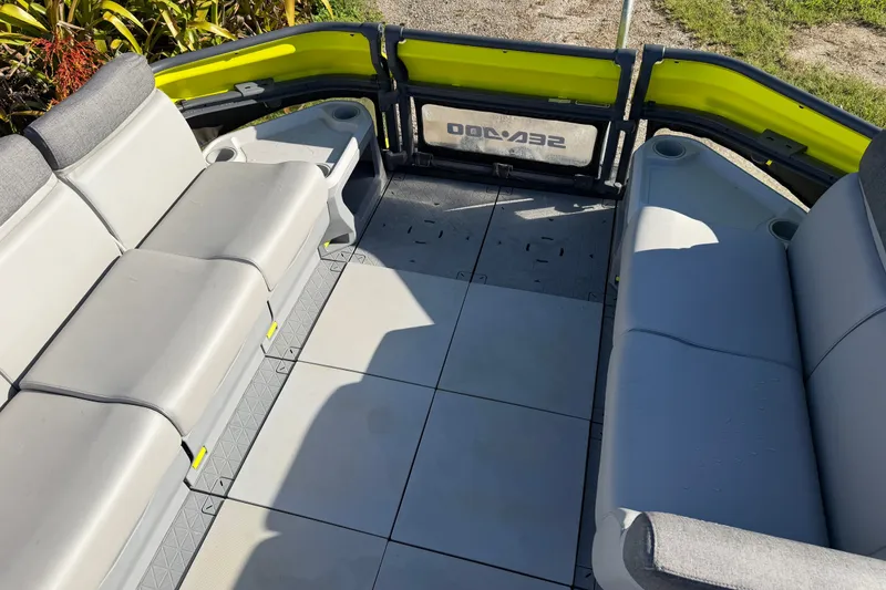 Slide: The Image of 2023 Sea-Doo Switch Sport 21 interior with gray seating and yellow accents. - 8