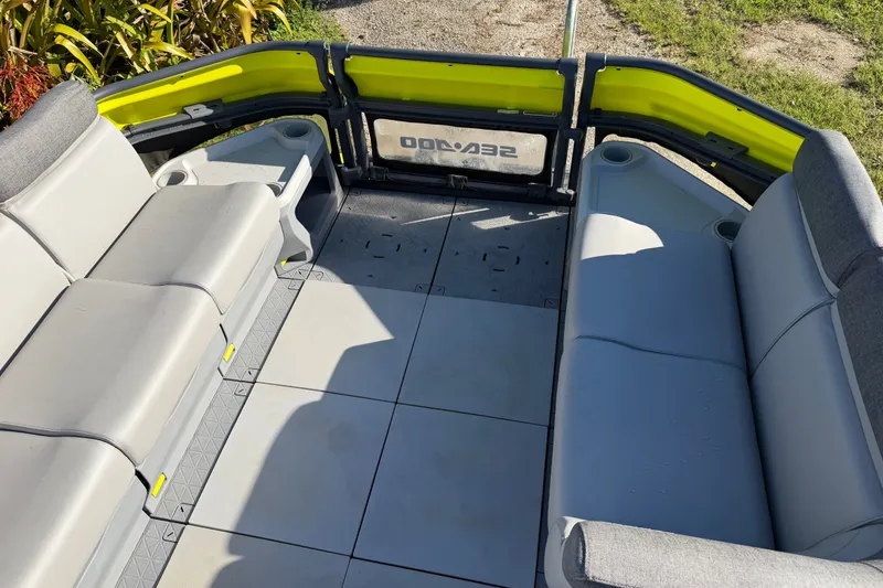 Slide: The Image of 2023 Sea-Doo Switch Sport 21 interior with gray seating and yellow accents. - 10