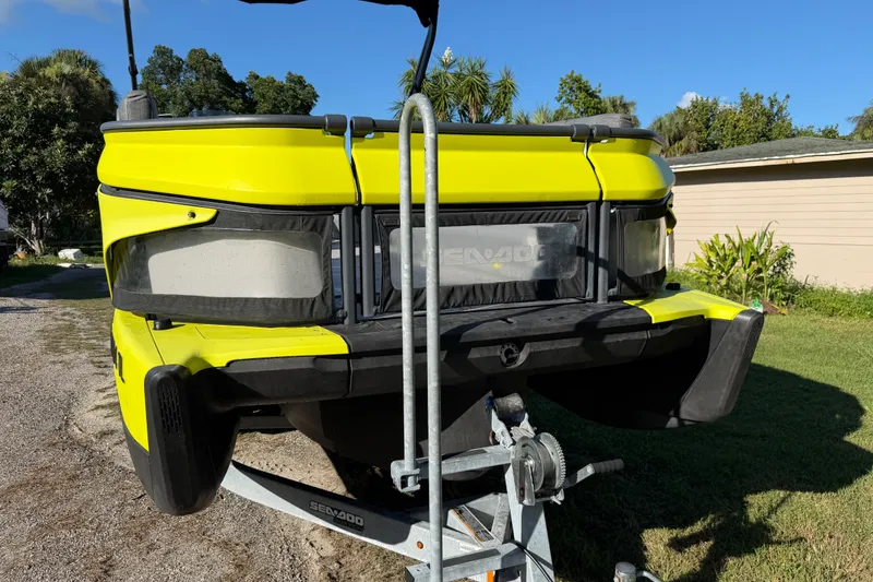 Slide: The Image of 2023 Sea-Doo Switch Sport 21 on trailer, vibrant yellow, parked outdoors. - 6