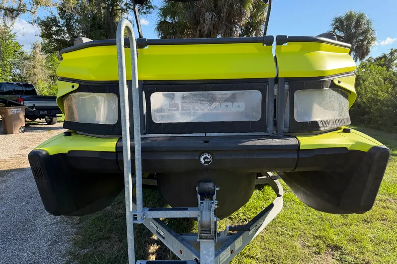 Slide: The Image of 2023 Sea-Doo Switch Sport 21 on trailer, vibrant yellow, parked outdoors. - 17