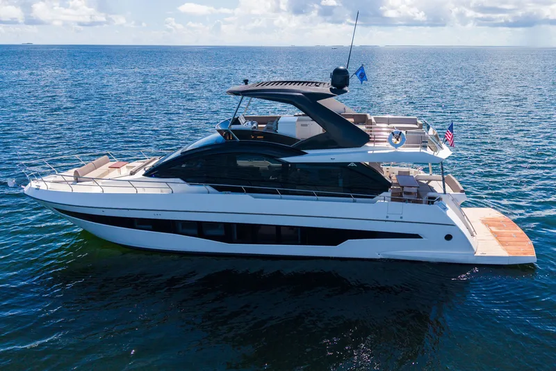 Slide: The Image of 2022 Astondoa 66 Fly yacht cruising on open water under a clear sky. - 4