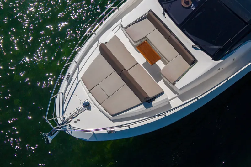 Slide: The Image of 2022 Astondoa 66 Fly yacht deck with luxurious seating and table, floating on sparkling water. - 7
