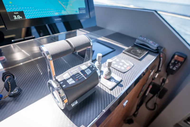 Slide: The Image of Control panel of 2022 Astondoa 66 Fly yacht with navigation equipment and throttle. - 31