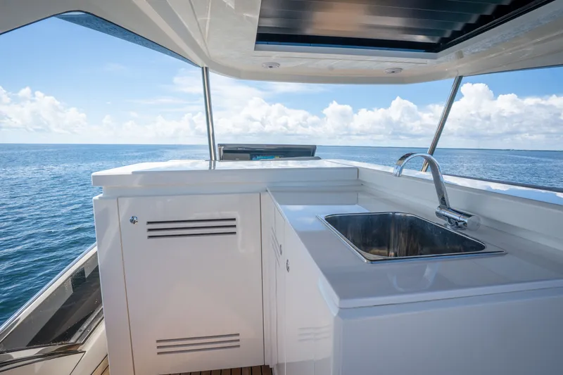 Slide: The Image of Luxurious 2022 Astondoa 66 Fly yacht with sleek outdoor sink and ocean view. - 11
