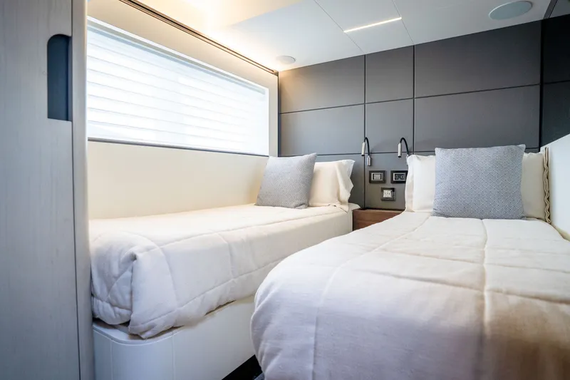 Slide: The Image of Luxurious twin cabin interior on 2022 Astondoa 66 Fly yacht, featuring modern design and cozy bedding. - 45