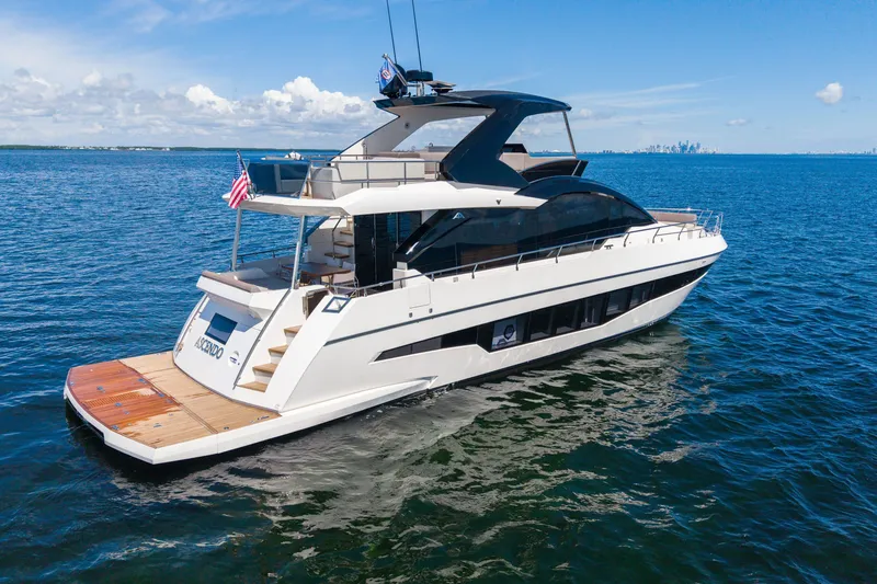 Slide: The Image of 2022 Astondoa 66 Fly yacht cruising on open water under a clear blue sky. - 5