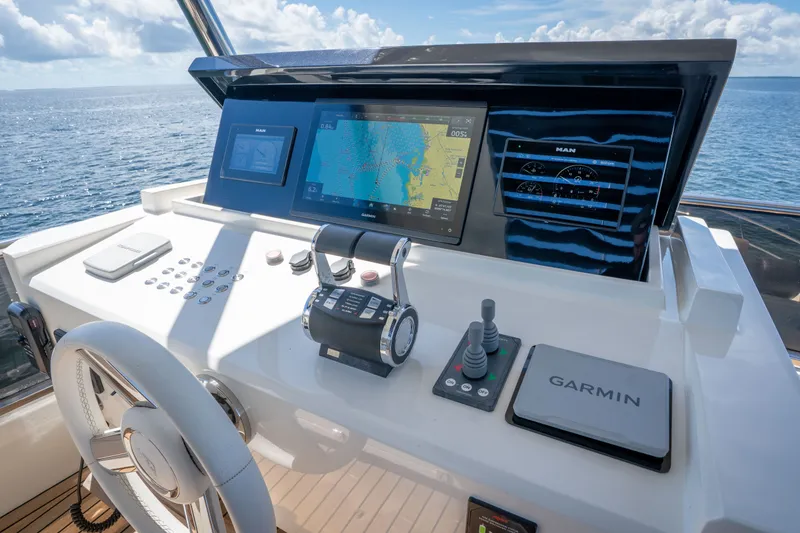 Slide: The Image of Cockpit of 2022 Astondoa 66 Fly yacht with Garmin navigation system and ocean view. - 14