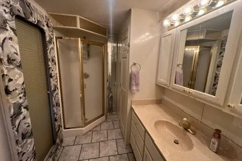 Slide: The Image of Luxurious bathroom in 1999 Fantasy Custom houseboat with elegant fixtures and spacious shower. - 43