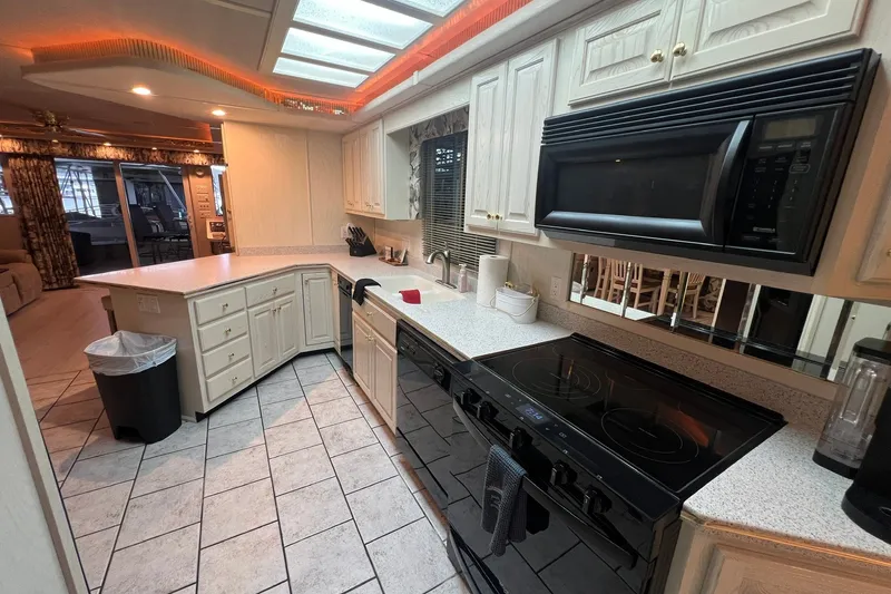 Slide: The Image of Spacious kitchen in a 1999 Fantasy 75' x 17' Custom houseboat with modern appliances. - 29