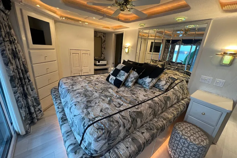 Slide: The Image of Luxurious bedroom in a 1999 Fantasy Custom houseboat with mirrored walls and elegant decor. - 36