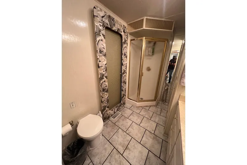 Slide: The Image of Bathroom in 1999 Fantasy Custom houseboat with tiled floor and shower enclosure. - 38