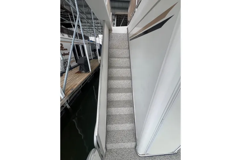 Slide: The Image of Staircase on a 1999 Fantasy 75' x 17' Custom houseboat, docked in a marina. - 7