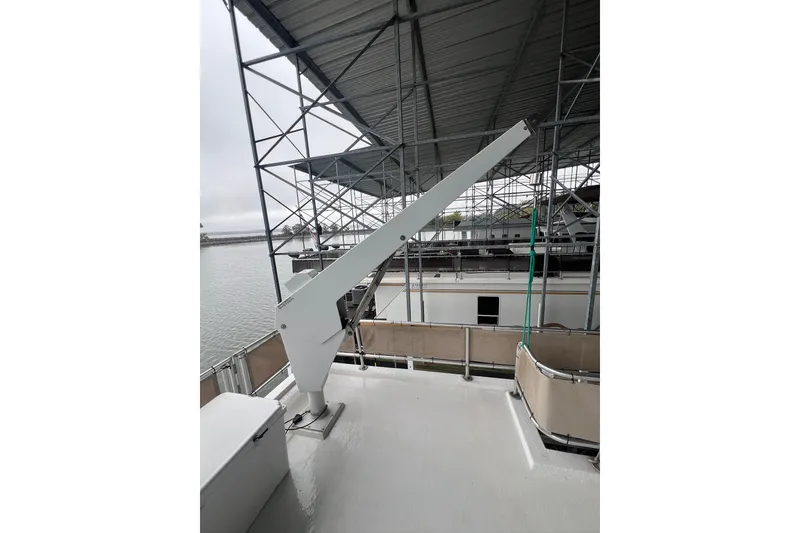 Slide: The Image of Rooftop view of a 1999 Fantasy 75' x 17' Custom boat with a crane. - 19