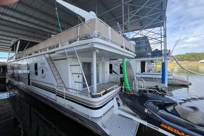Slide: The Image of Houseboat docked with jet ski, Fantasy 75' x 17' Custom, 1999 model. - 5