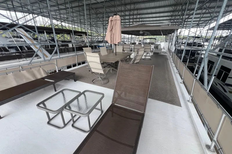 Slide: The Image of Rooftop deck of a 1999 Fantasy 75' x 17' Custom houseboat with seating and tables. - 15